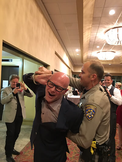Attorney Darren Kavinoky gets "arrested" all in good fun at the annual CHP Christmas Party, December 2015.