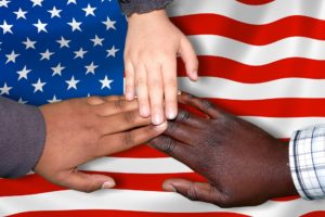 diverse hands over an american flag